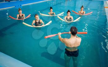 Male instructor and female group, aqua aerobics training in the pool. Man and women in the water, sport swimming fitness workout