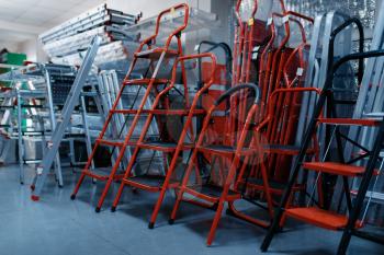 New aluminum stepladders in tool store, nobody. Showcase with ladders, choice of equipment in hardware shop, instrument supermarket