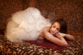 Woman in foam, turkish bath, hamam. Skin and body care