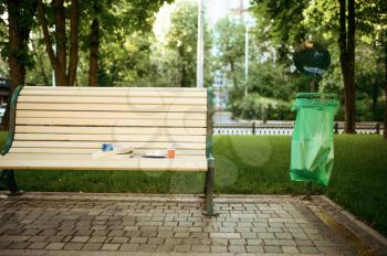 Trash on the bench in park, volunteering motivator. Ecological restoration, eco lifestyle, ecology care, environment cleaning concept
