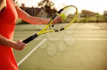 Female tennis player with racket and ball on outdoor court. Active healthy lifestyle, sport game competition, fitness training with racquet