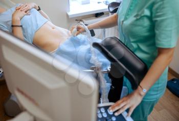 Female gynecologist makes ultrasound scan. Gynecological examination in clinic, gynecology consultation, ultrasonography diagnostic or scanning. Doctor in hospital