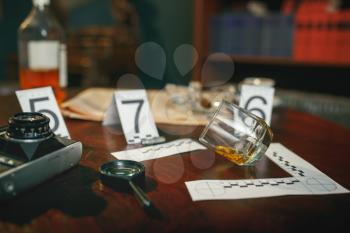 Crime scene, evidence with numbers on the table closeup, nobody. Detective investigation concept, magnifying glass and retro photo camera, vintage style room interior on background
