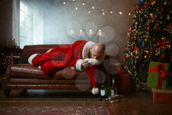 Bad drunk Santa claus vomiting in a hat, hangover after nasty party, humor. Unhealthy lifestyle, bearded man in holiday costume, new year and alcoholism