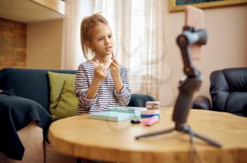 Female child records vlog, creative hobby, little vlogger. Kid blogging in home studio, social media for young audience, online internet broadcast,