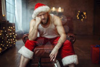 Bad Santa claus drinks alcohol, nasty party. Unhealthy lifestyle, bearded man in holiday costume, new year and alcoholism