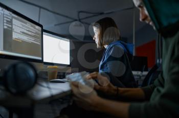 Male and female hackers works on computers in darknet, dangerous teamwork. Illegal web programmer at workplace, criminal occupation. Data hacking, cyber security