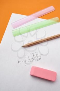 Pencil, ruler and rubber on paper sheet, orange background. Office stationery supplies, school or education accessories, writing and drawing tools