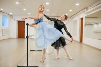 Master rehearsing with young ballerina in class. Ballet school, female dancers on choreography lesson, girls practicing grace dance