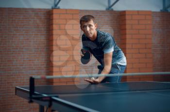 Man play table tennis, male ping pong player. Sportsman playing table-tennis indoors, sport game with racket and ball, active healthy lifestyle