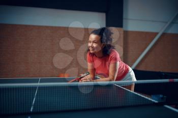 Woman at the net, table tennis training, ping pong player. Sportive girl playing table-tennis indoors, sport game with racket, active healthy lifestyle