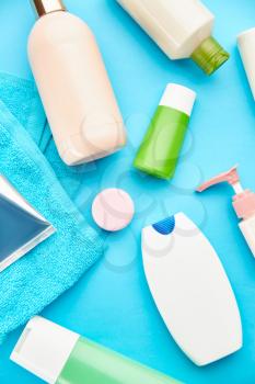 Oral and skin care products, blue background, nobody. Morning healthcare procedures concept, toothcare, toothbrush and toothpaste, brush and cream