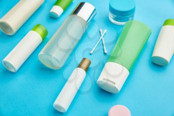 Care products on blue background, nobody. Healthcare procedures concept, fashion cosmetic. Healthcare procedures concept, hygiene tools