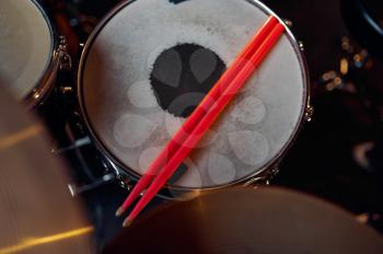 Professional drum kit and sticks closeup, nobody. Rock band concert repetition, live sound performing concept, percussion musical instrument