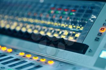 Mixing console, buttons closeup, studio and concert equipment, nobody. Professional audio mixer panel, sound engineer or musician workplace, soundboard