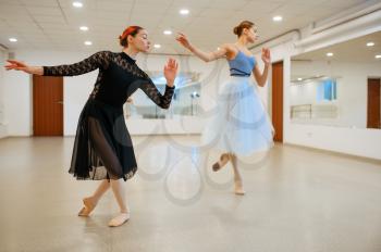 Choreographer works with young ballerina in class. Ballet school, female dancers on choreography lesson, girls practicing grace dance