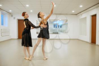 Master rehearsing with young ballerina in class. Ballet school, female dancers on choreography lesson, girls practicing grace dance