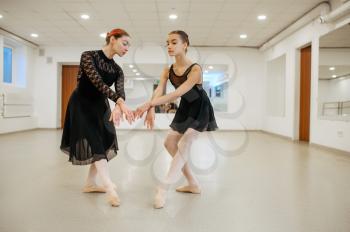 Teacher rehearsing with young ballerina in class. Ballet school, female dancers on choreography lesson, girls practicing grace dance