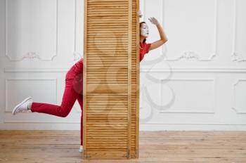 Two mime artists, scene with wooden partition. Pantomime theater, parody comedian, positive emotion, humour performance, funny face mimic and grimace