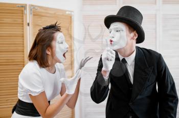 Two mime artists, secret lovers parody. Pantomime theater, comedian, positive emotion, humour performance, funny face mimic and grimace
