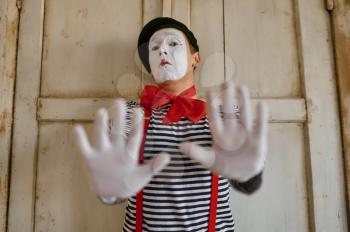 Male mime artist, gesture scene, parody comedy. Pantomime theater, comedian, positive emotion, humour performance, funny face mimic and grimace