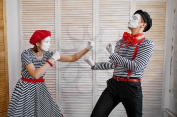 Two clowns, mime artists, boxing parody, comedy. Pantomime theater, comedian, positive emotion, humour performance, funny face mimic and grimace