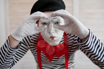 Mime artist, binoculars gesture, parody comedy. Pantomime theater, comedian, positive emotion, humour performance, funny face mimic and grimace