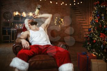 Bad Santa claus drinks alcohol, nasty party. Unhealthy lifestyle, bearded man in holiday costume, new year alcoholism