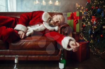 Bad drunk Santa claus sleeps on sofa, hangover after nasty party, humor. Unhealthy lifestyle, bearded man in holiday costume, new year and alcoholism