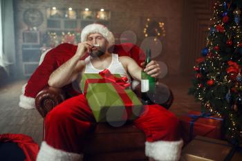 Bad Santa claus takes drugs with alcohol, nasty cocaine party, humor. Unhealthy lifestyle, bearded man in holiday costume, new year and alcoholism