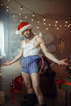 Bad shameless Santa claus in underpants, nasty party, humor. Unhealthy lifestyle, bearded man in holiday costume, new year and alcoholism