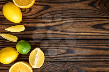 Fresh lemons isolated on wooden background, top view. Organic vegetarian food, grocery assortment, natural eco products, healthy lifestyle concept