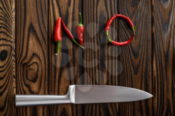 Red pepper NO word isolated on wooden background, top view. Organic vegetarian food, grocery assortment, natural eco products, healthy lifestyle concept