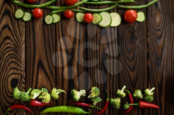 Fresh vegetable decoration on wooden background, top view. Organic vegetarian food, grocery assortment, natural eco products, healthy lifestyle concept