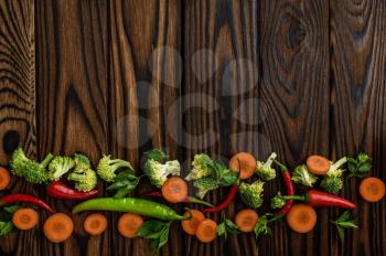 Fresh vegetable ornament on wooden background, top view. Organic vegetarian food, grocery assortment, natural eco products, healthy lifestyle concept