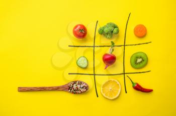 Vegan cross-zero game isolated on yellow background. Organic vegetarian food, grocery assortment, natural eco products, healthy lifestyle concept
