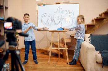 Two children bloggers makes christmas blog, little vloggers. Kids blogging in home studio, social media for young audience, online internet broadcast
