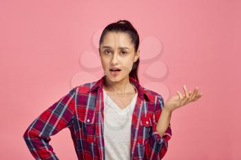 Surprised woman portrait, pink background, emotion. Face expression, female person looking on camera in studio, emotional concept, feelings