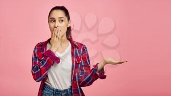 Terrified woman portrait, pink background, emotion. Face expression, female person looking on camera in studio, emotional concept, feelings