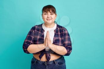 Funny overweight woman, body positive, blue background. Obesity fighting, cheerful female person without complexes