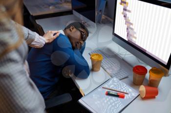 Woman looks on sleeping manager, night office lifestyle. Tired male persons at laptop, dark interior on background, modern workplace