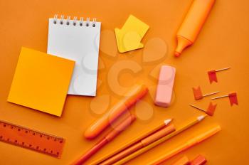 Office stationery supplies,macro view, orange background. School or education accessories