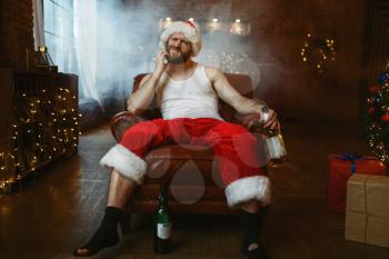 Bad Santa claus drinks alcohol, nasty party. Unhealthy lifestyle, bearded man in holiday costume, new year and alcoholism