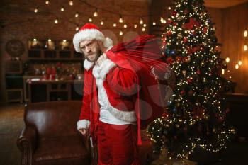 Bad drunk Santa claus brings gifts, nasty party. Unhealthy lifestyle, bearded man in holiday costume, new year alcoholism