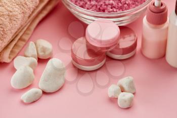 Skin care products and pebbles on pink background, nobody. Healthcare procedures concept, hygiene cosmetic, healthy lifestyle, spa and bath