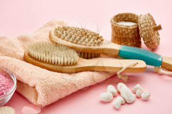 Skin care products, pebbles and towel on pink background, nobody. Healthcare procedures concept, hygiene cosmetic, healthy lifestyle, spa and bath