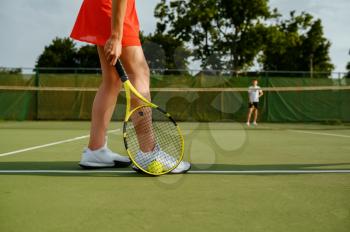 Tennis players with rackets on outdoor court. Active healthy lifestyle, people play sport game, fitness training with racquets