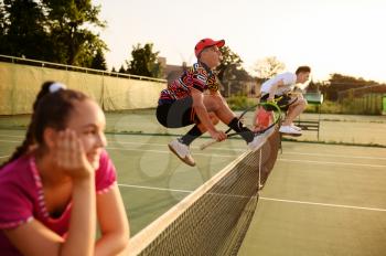Mixed doubles tennis, players jump through the net, outdoor court. Active healthy lifestyle, sport with racket and ball, fitness workout with racquets