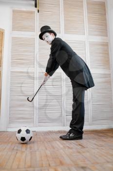 Male mime artist, gentleman with the cane and football ball, golf parody. Pantomime theater, comedian, positive emotion, humour performance, funny face mimic and grimace