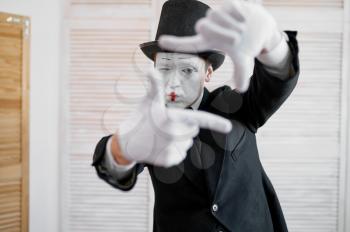 Male mime artist, photo camera gesture, photographer parody. Pantomime theater, comedian, positive emotion, humour performance, funny face mimic and grimace